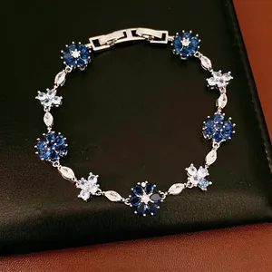 Elegant silver-toned bracelet featuring blue and white zircon flower motifs with a secure clasp