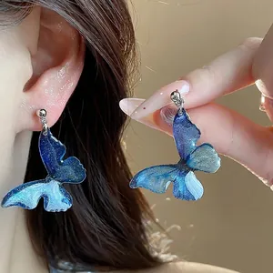 Blue resin butterfly clip-on earrings for non-pierced ears, elegant and artistic.