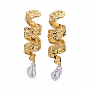 Vintage golden spiral drop earrings with baroque pearl detail and wrinkled metal texture