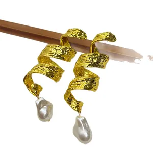 Elegant vintage gold spiral earrings with irregular baroque pearls in heavy metal style