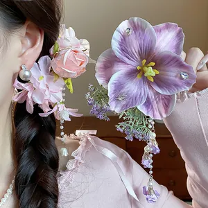 Detailed view of sweet fabric flower hair clips with elegant pearl and tassel drops