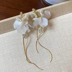 French style elegant floral tassel drop earrings with matte white petals and gold finish.