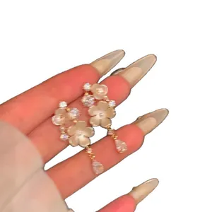 Elegant French style floral tassel earrings featuring sparkling zirconia crystals on white background