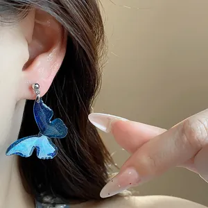 Elegant blue resin butterfly earrings with glitter detail for women