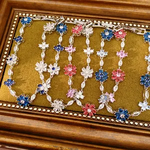 Detailed view of vintage-style floral bracelets with colorful zircons and snap clasp