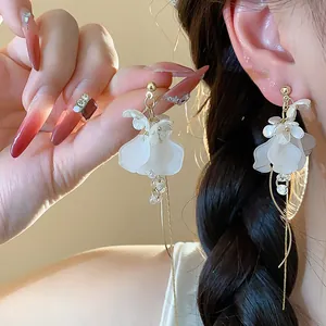 Detailed close-up of elegant French style white flower tassel earrings for women