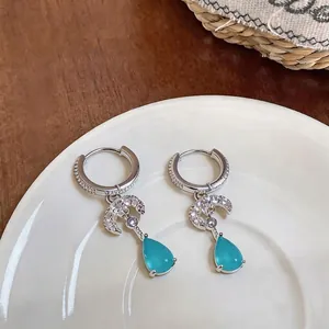 Elegant blue teardrop and zircon moon charm hoop earrings with a polished silver finish