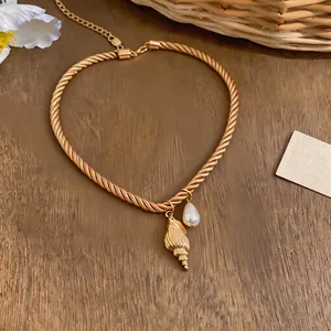 Vintage gold twisted rope necklace with realistic shell pendant and elegant pearl drop