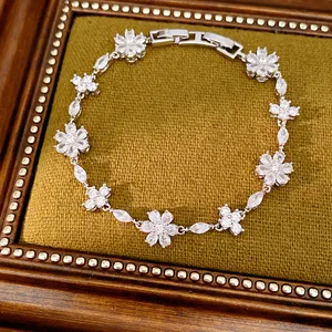 Detailed view of vintage zircon flower and cross linked bracelet with silver finish