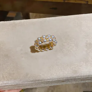 Detail view of a luxury 18K gold plated double layer pearl ring with fine rhinestones.