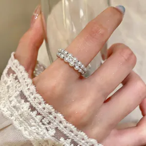 Elegant double-layered white pearl ring detail with sparkling crystal accents and lace