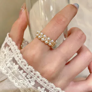 Close-up view of elegant double-layer pearl ring with gold plating and sparkling rhinestones