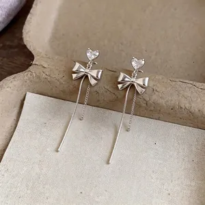 Elegant silver bow earrings with heart-shaped zircon and long dangling chain tassels
