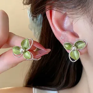 Elegant 18k gold plated flower stud earrings with green petals and silver needles