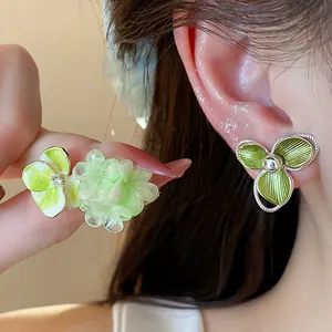 Elegant green floral stud earrings featuring 18k gold plating and zircon accents.