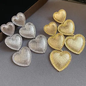 Elegant triple heart tassel drop earrings with textured pleated finish in gold and silver