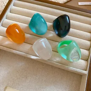 Trendy set of chunky candy-colored resin rings for women, minimalist fashion design