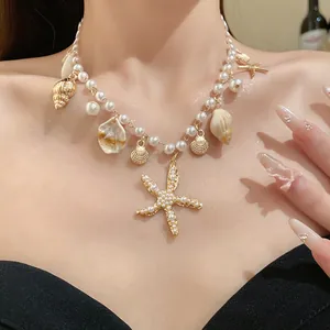 Close-up of pearl necklace with gold starfish and shell charms worn on neck