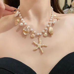 Elegant pearl necklace featuring starfish and shell charms worn by a female model