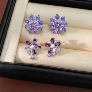 Detailed macro shot of elegant purple zircon and pearl flower-shaped ear clips