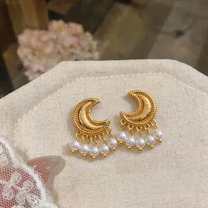 Elegant vintage golden crescent moon earrings featuring pearl tassels and details