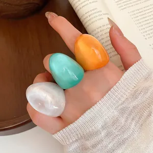 Set of chunky candy colored resin rings in pearlescent white, turquoise and orange.
