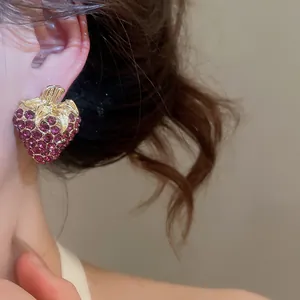 Detailed close-up view of vintage-style strawberry stud earring with purple rhinestones