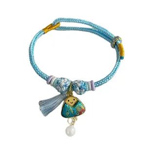 Handwoven light blue braided rope bracelet with triangle charm and pearl pendant