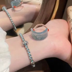 Detailed view of a vintage resin ring with Fu character and its matching woven bracelet set.