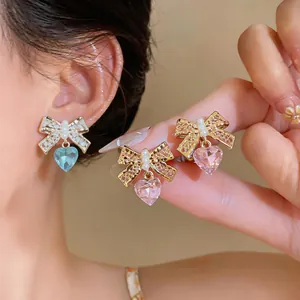 Close-up of bowknot heart-shaped zircon and pearl ear clips for non-pierced ears