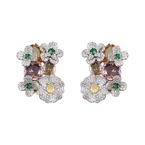 Vintage silver needle floral stud earrings with multi-colored zircons on white background