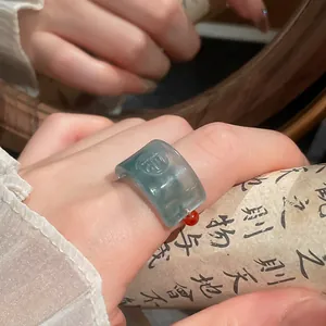 Macro view of a translucent blue resin ring featuring an embossed Chinese Fu character