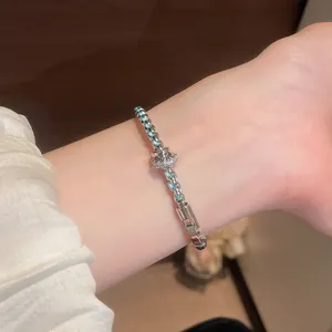 Detailed macro shot of a vintage braided bracelet with turquoise accents on a wrist