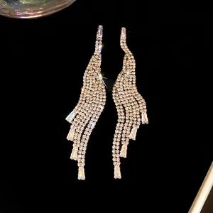 Elegant silver-tone long sparkling zircon tassel earrings on black velvet background