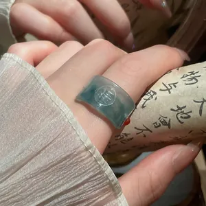 Close-up detail of retro resin ring with Fu character relief and jade-like finish