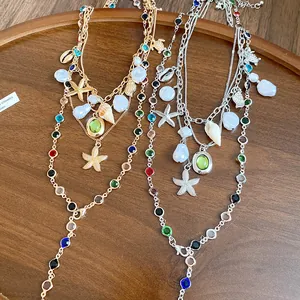 Close-up of multi-layer marine necklace with starfish, shell pendants and pearls