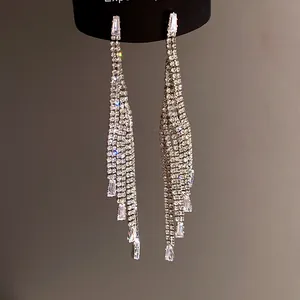 Macro detail of elegant silver fringe tassel earrings with shimmering zirconia stones