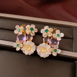 Elegant close-up of vintage floral zircon stud earrings with pink and yellow gemstones