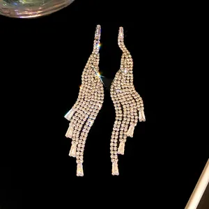 Detailed macro view of elegant silver tassel earrings with shimmering cubic zirconia