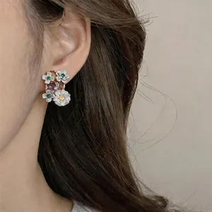 Detailed close-up of a floral zircon earring with vintage silver pin and fashion style.