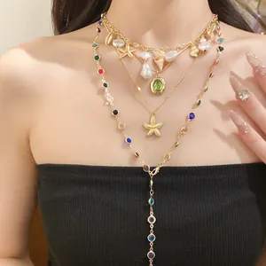 Detailed view of layered gold necklace with pearls, starfish, and colored gemstones