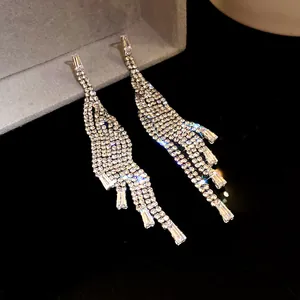 Detailed view of luxury silver-toned tassel drop earrings with sparkling zircon stones