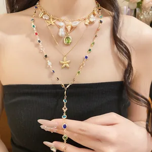 Detail of multi-layered gold necklaces with white pearls, starfish pendants, and colorful beads