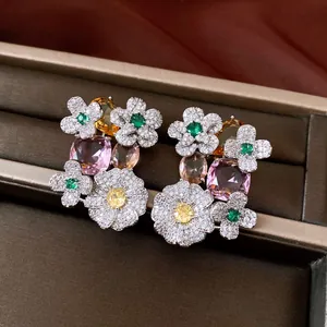 Close-up of vintage flower earrings with multi-color zircon floral clusters