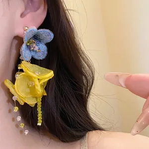 Elegant chiffon flower tassel earrings with vibrant blue and yellow petals.