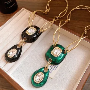 Vintage green and black wrinkled pendant necklace with crystal set on wavy gold chain.