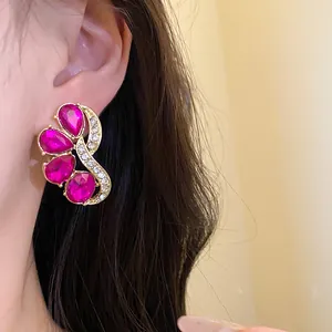 Close-up of vintage fuchsia floral stud earrings with fuchsia gemstones