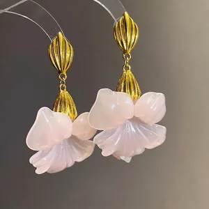 Elegant vintage style resin flower drop earrings with textured golden shell accents