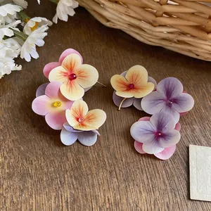 Elegant multi-layered fabric flower petal stud earrings with pink and purple gradients.