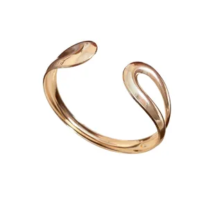 Elegant minimalist metallic water-drop open cuff bracelet with a polished rose gold finish